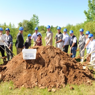 MDI employees digging large pile of dirt