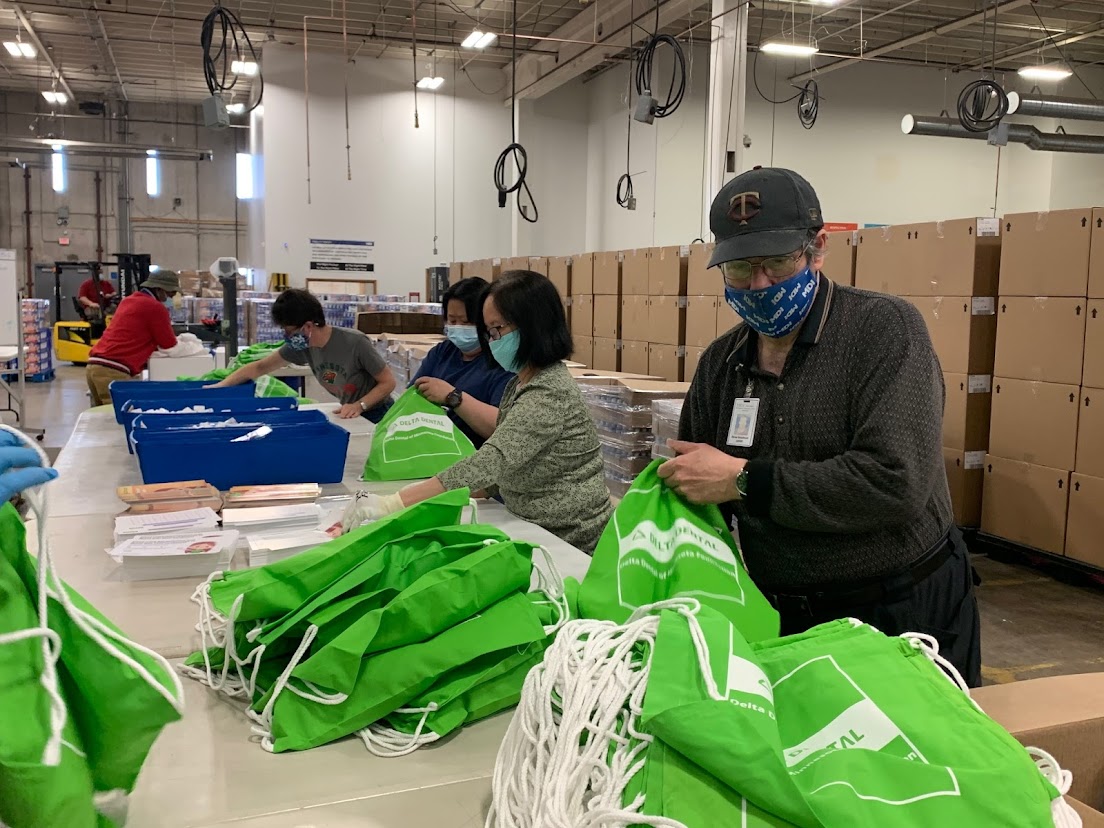 Delta Dental assembly line workers packing bags
