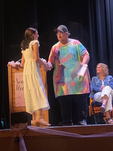 MDI Success at Work 2025 Recipient walking on stage to receive scholarship