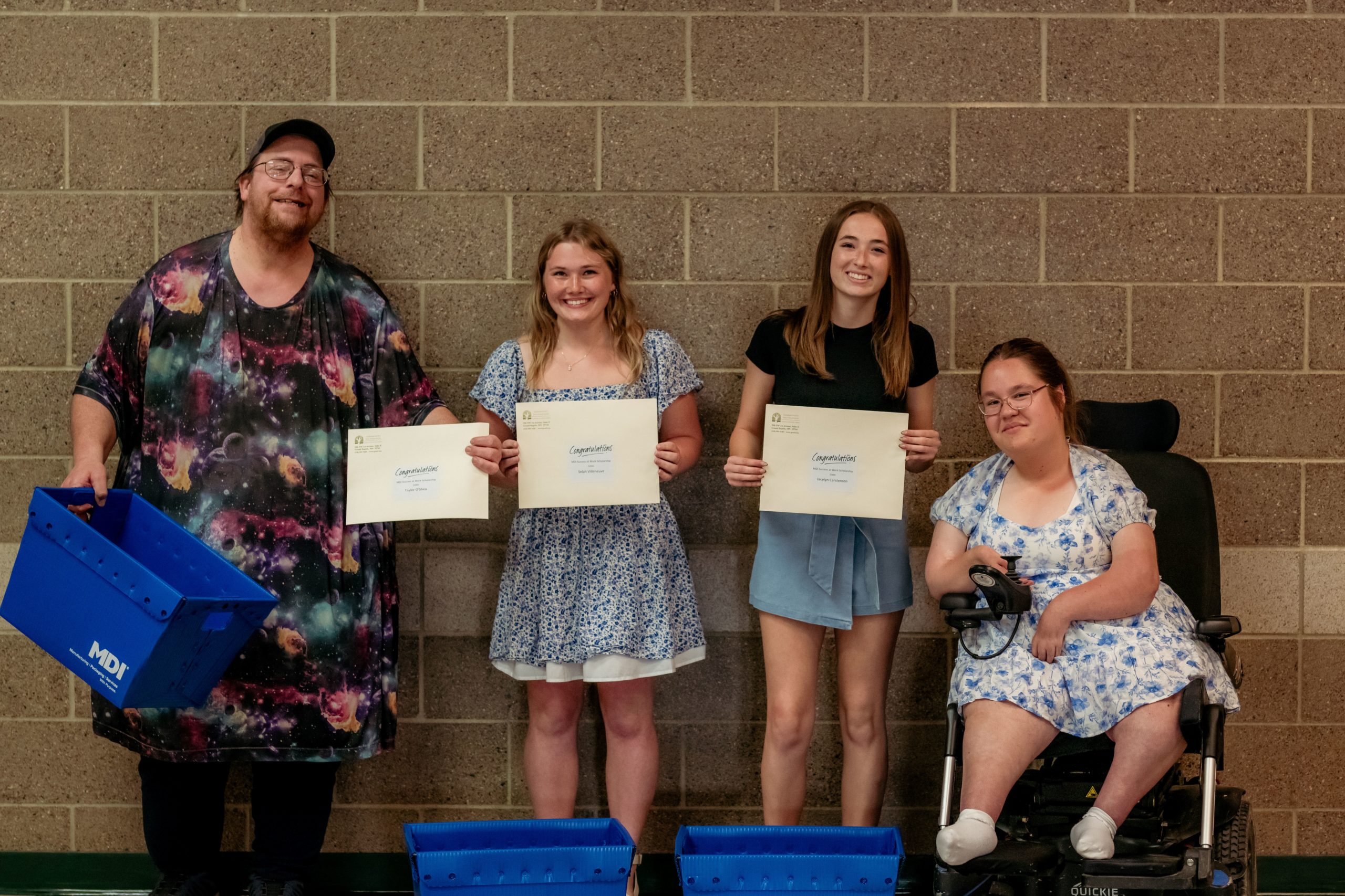 MDI Success at Work 2025 Recipients standing in a row holding their scholarships