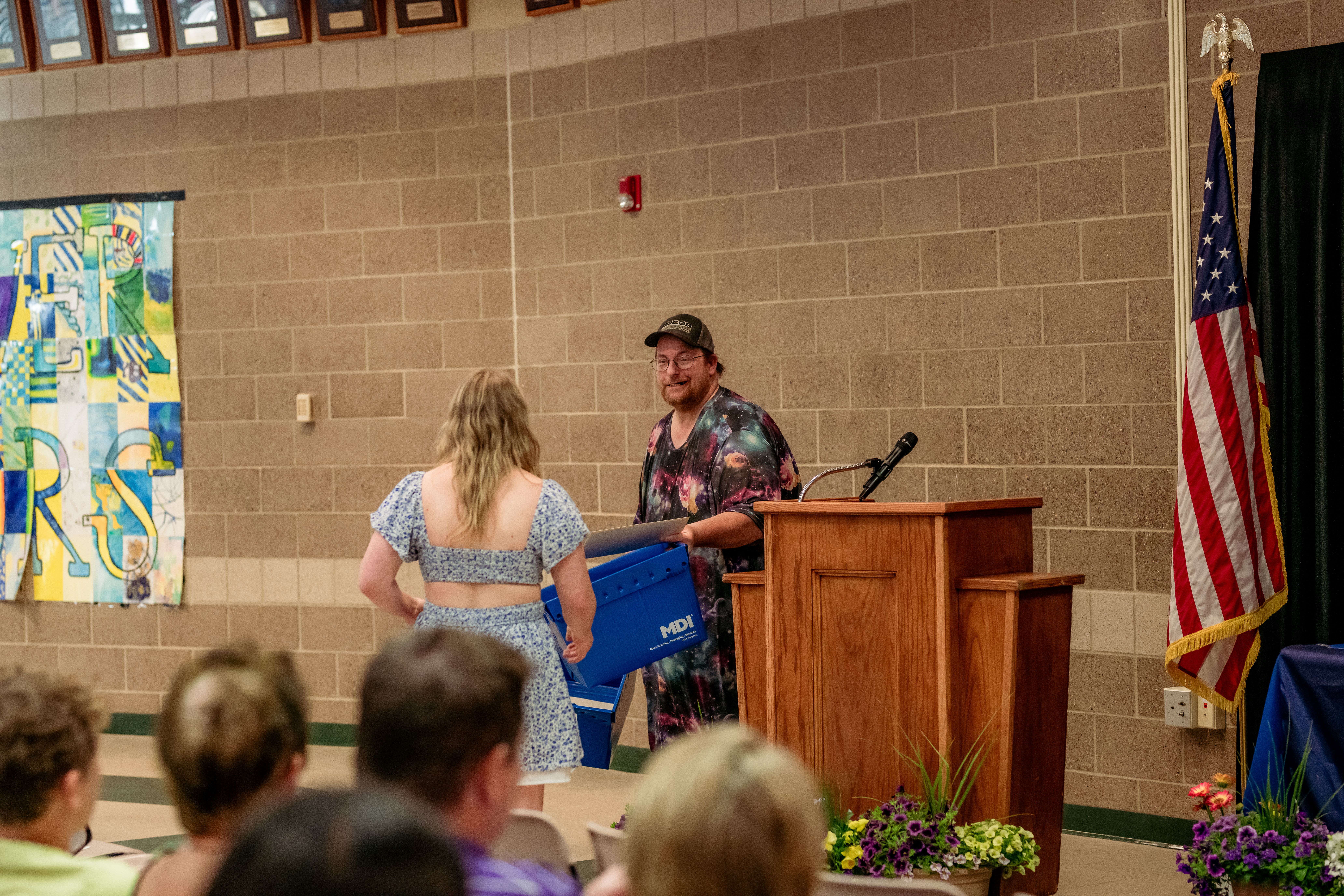 MDI Success at Work 2025 Recipient walking to the podium to receive scholarship