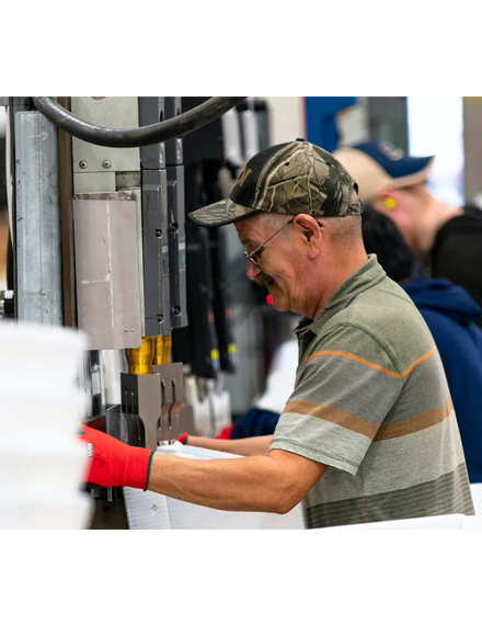 Man working on a production line doing production services and labor